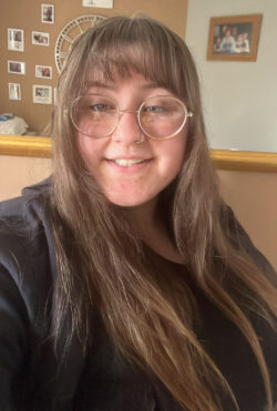 Colour head and shoulders photograph of Anglia Ruskin student Chloe Boast, wearing a dark grey top, with small photos in the background