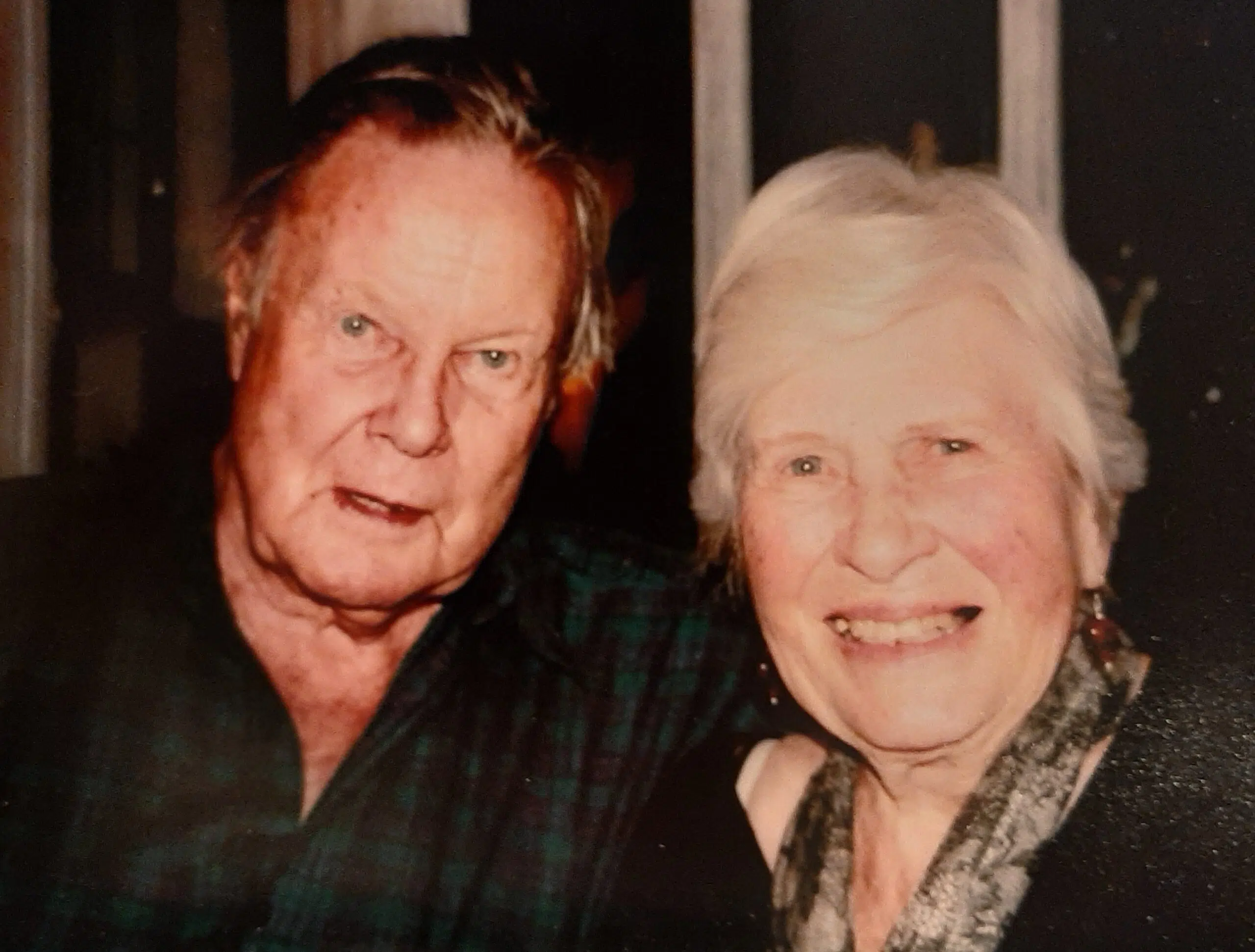 Corelli and Ruth Barnett looking directly at the camera and smiling