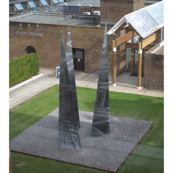 A photograph of Clarke's sculpture 'Past, Present, Future' outside the Moller Institute