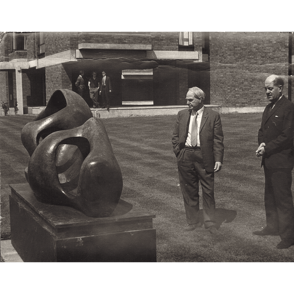 A photograph of two men admiring a Henry Moore sculpture