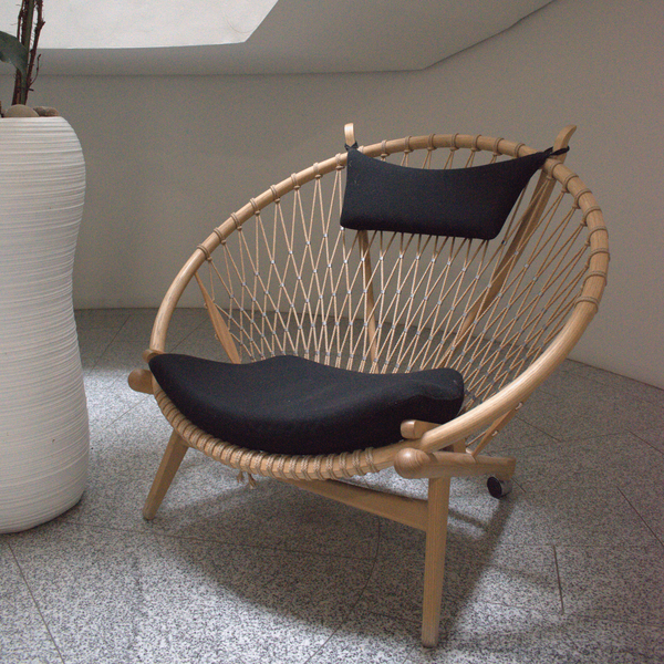 A photograph of a Circle Chair, as designed by Hans J Wegner