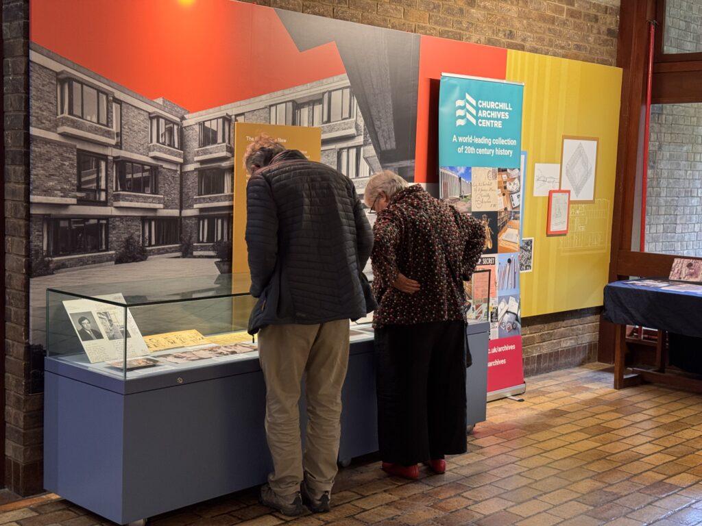 Attendees look at display cases in the Wolfson Foyer