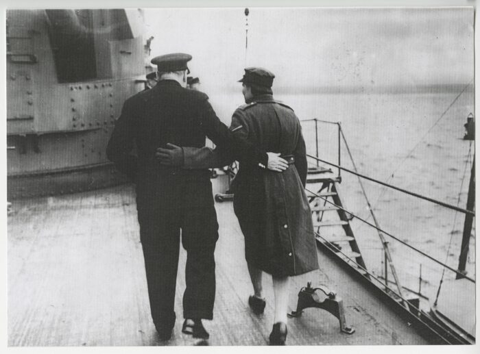 Black and white photo of the back view of Churchill and Mary Churchill walking on the deck of HMS Duke of York